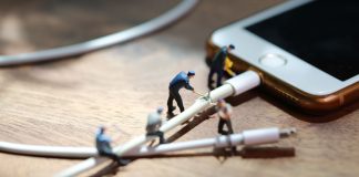 Google prohíbe las apps de juego online y apuestas en la Play Store de Brasil Hombres en miniatura cortan un cable conectado a un celular.